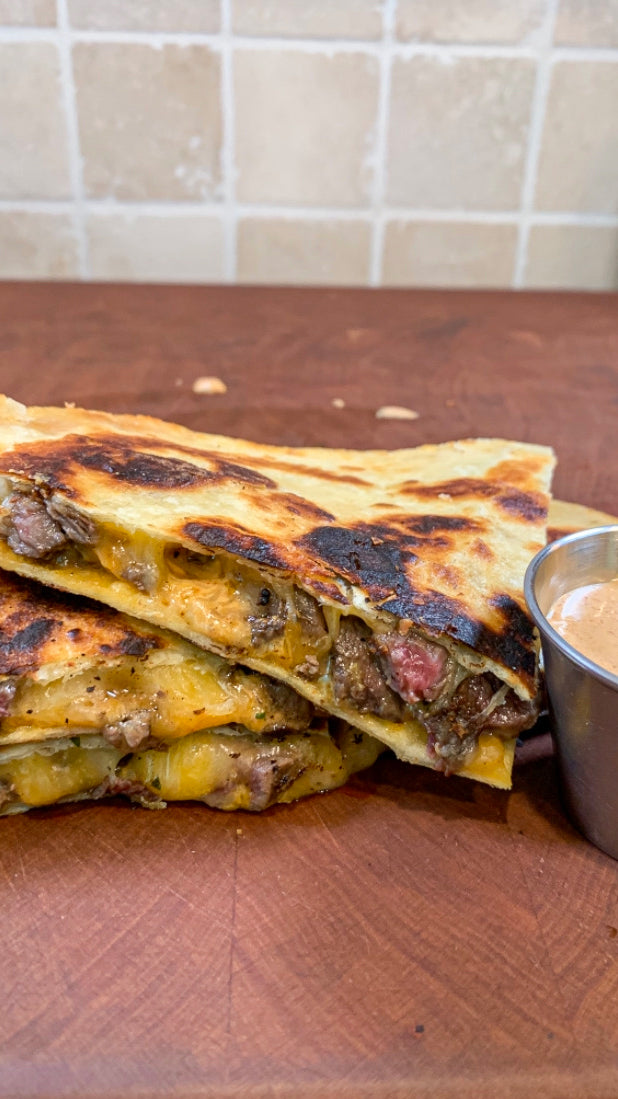 Carne Asada Skirt Steak Quesadilla served with a jalapeño cream sauce.