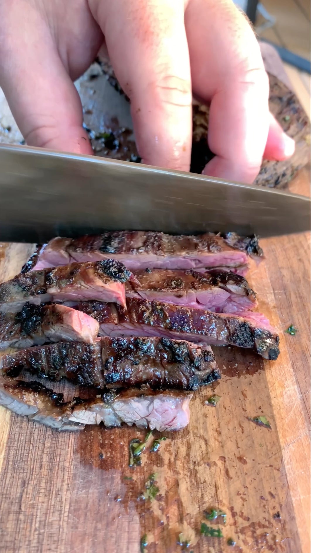 Cutting a Certified ONYA skirt steak from BetterFed Beef across the grain after cooking and searing over high heat on a Burch Barrel grill