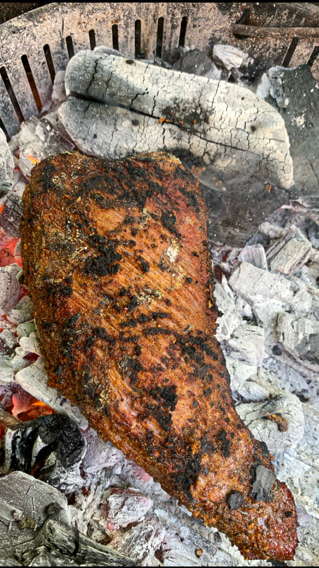 Reverse sear tri tip steak and sear directly on the coals for a caveman style sear with a flavorful maillard reaction flavor