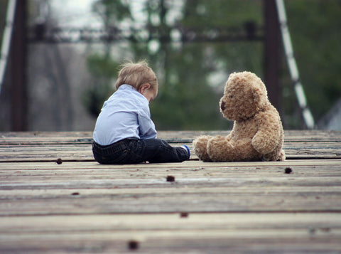 Little boy playing with his soft toy, teddy bear