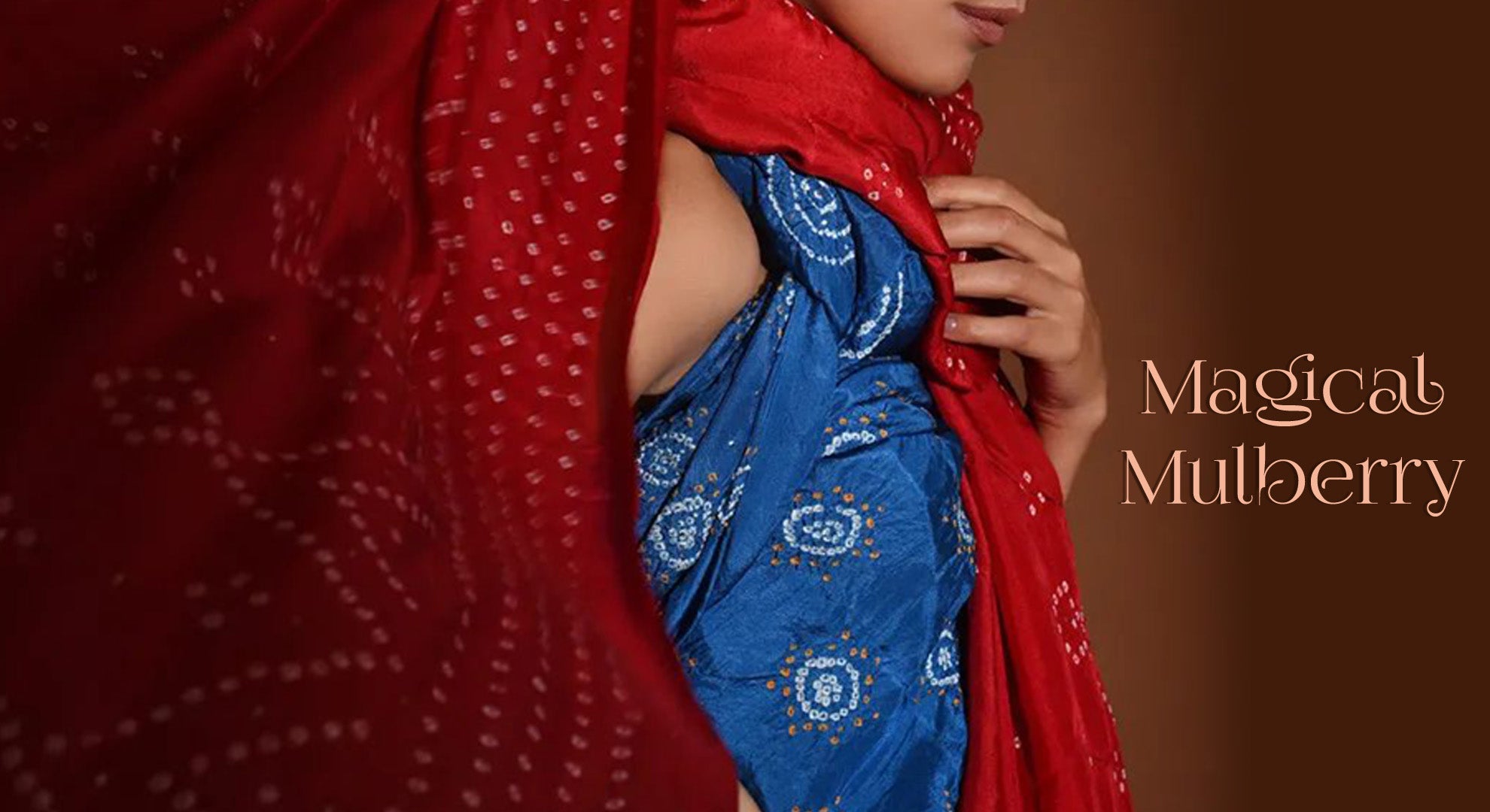 Woman wrapped in Red and Indigo Mulberry silk saree with intricate & traditional Bandhani designs