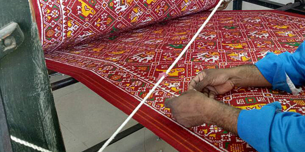 Man weaving Red Patola Saree on Handloom