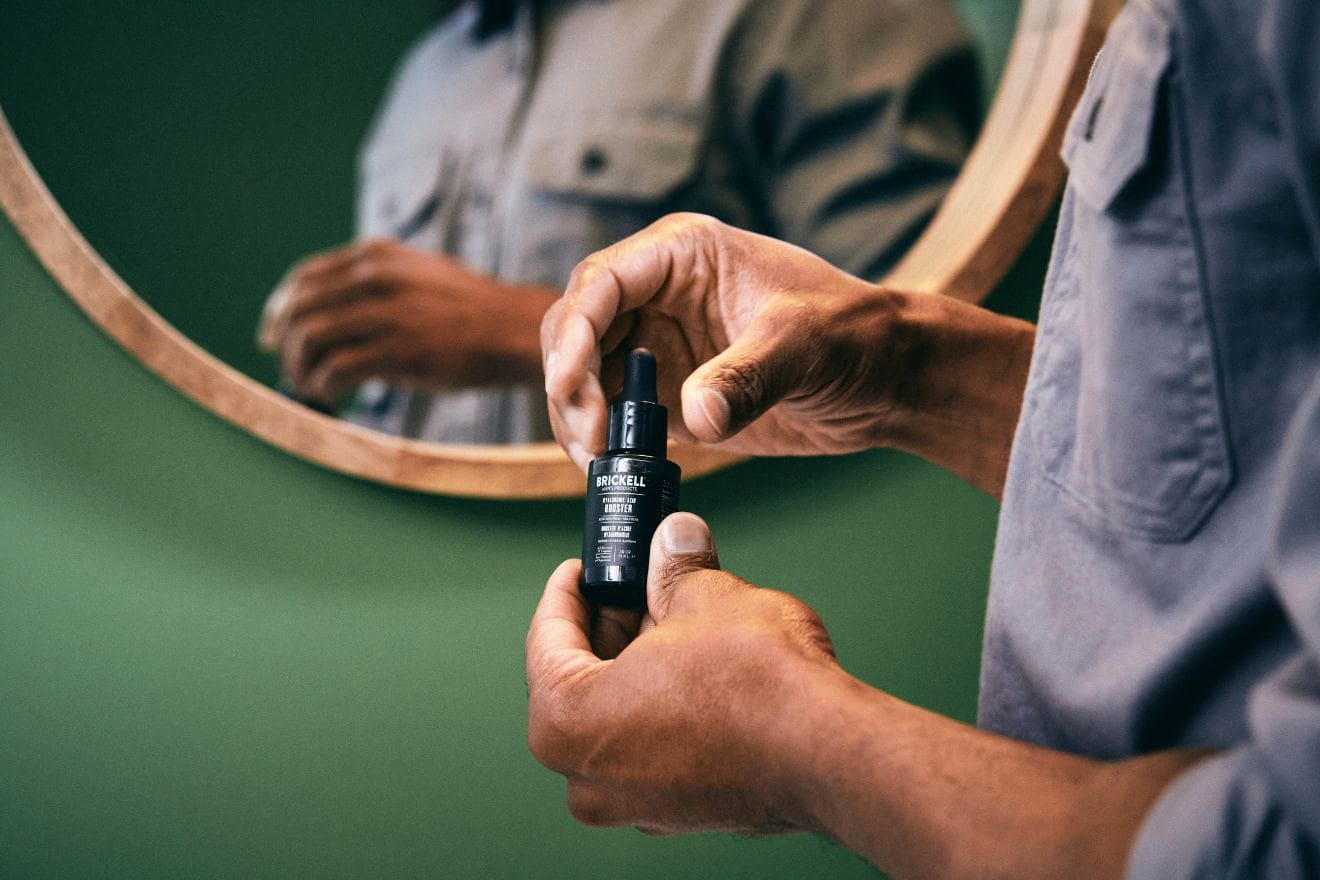 Man holding skincare serum