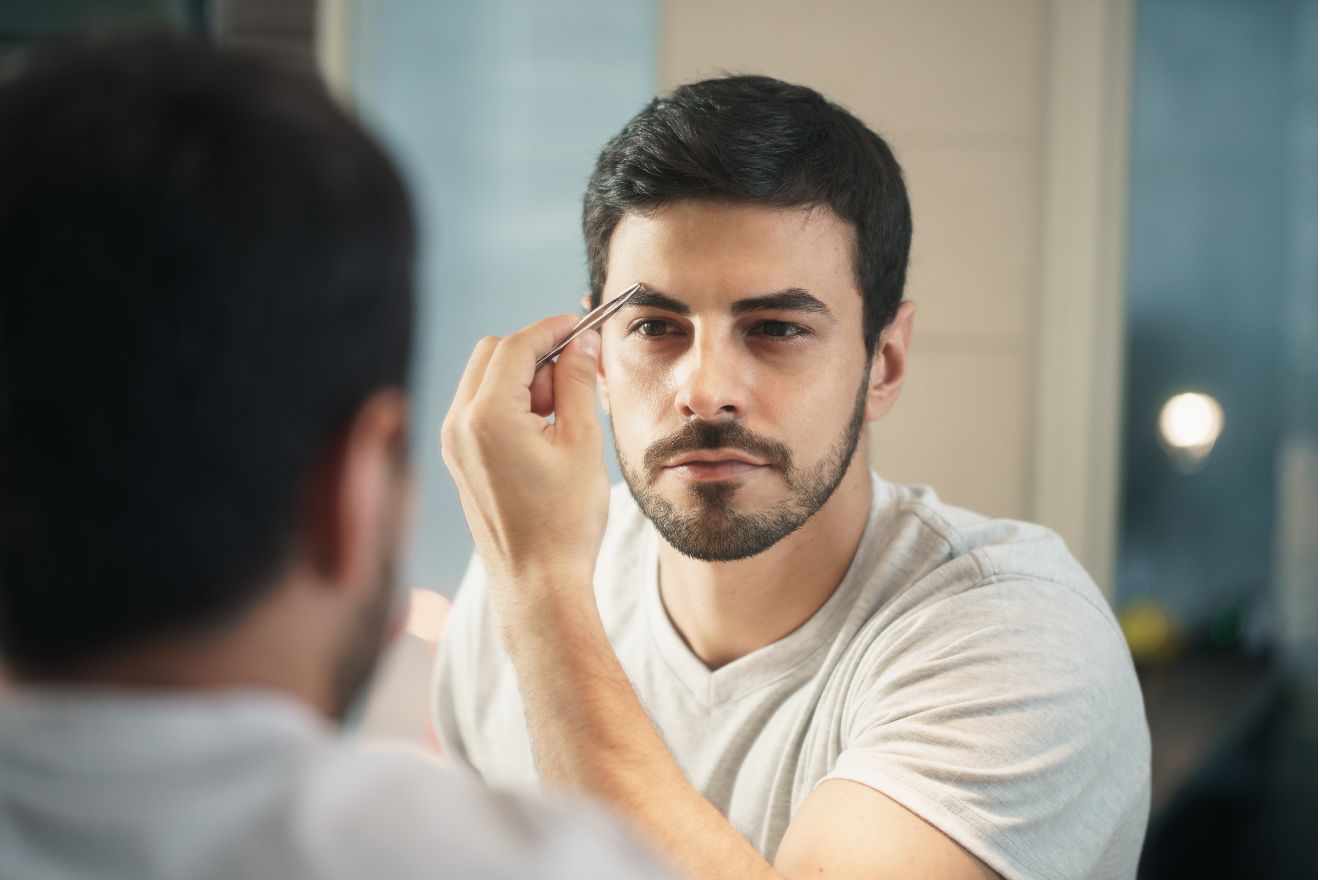 Man trimming his eyebrows