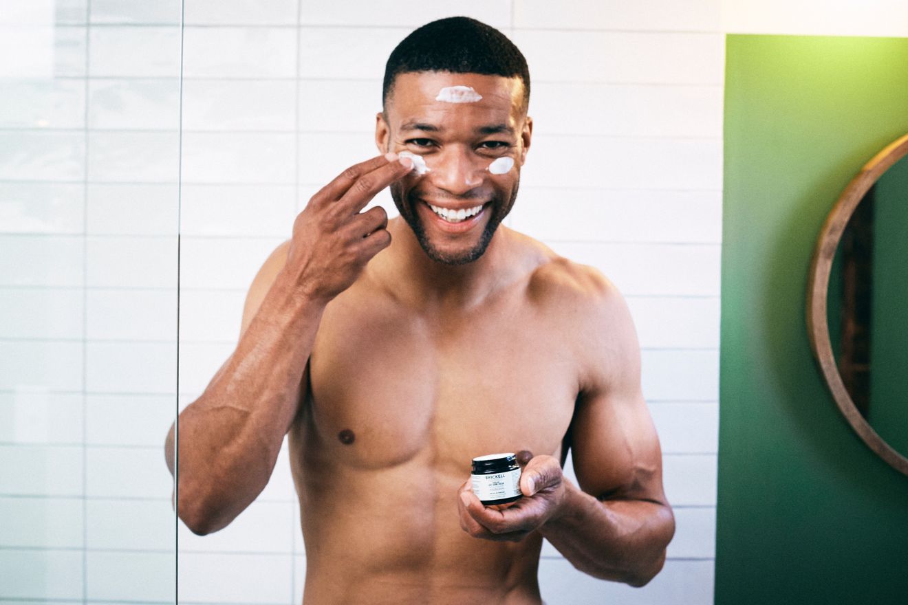 Man applying skincare product to face