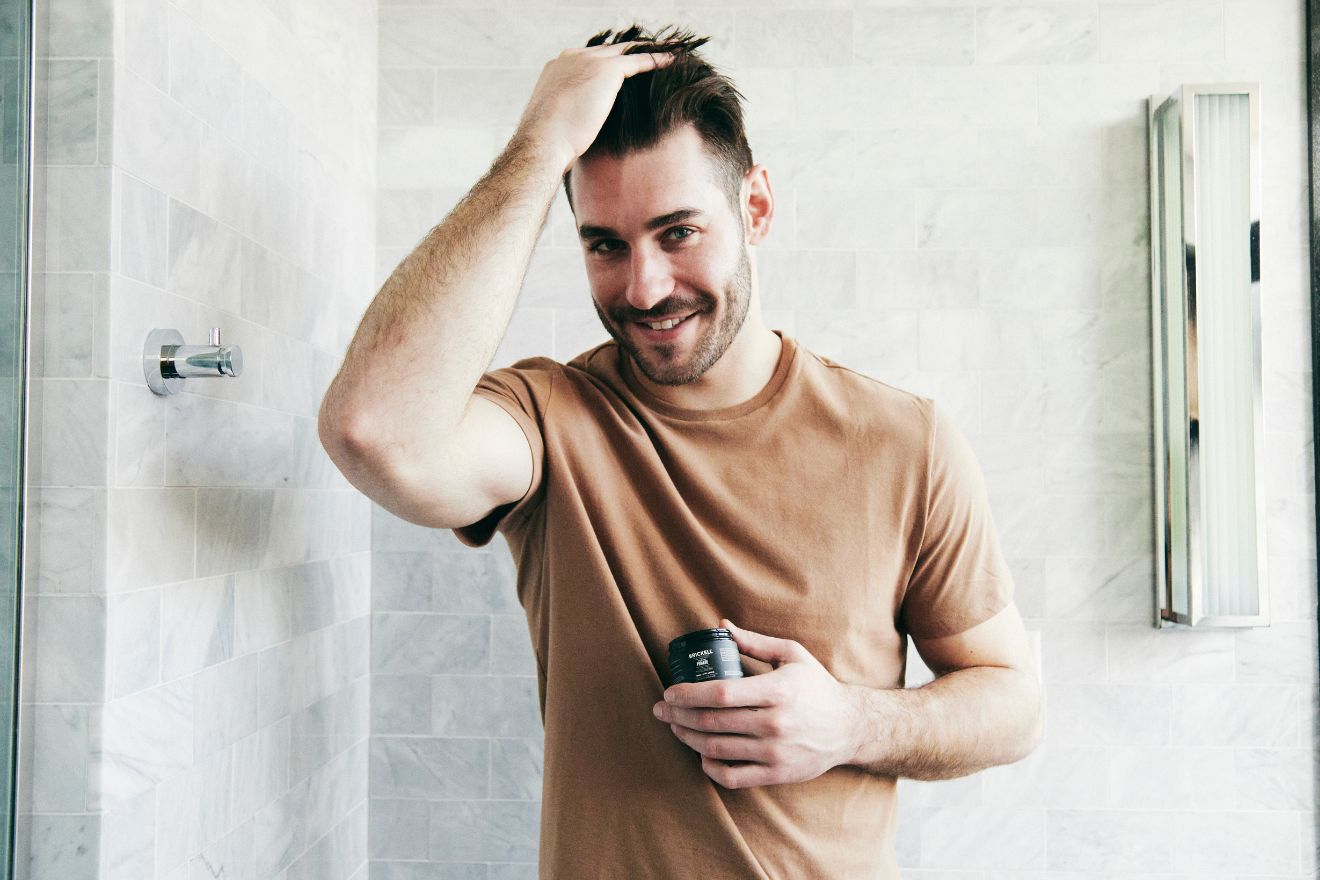 Man applying pomade to hair