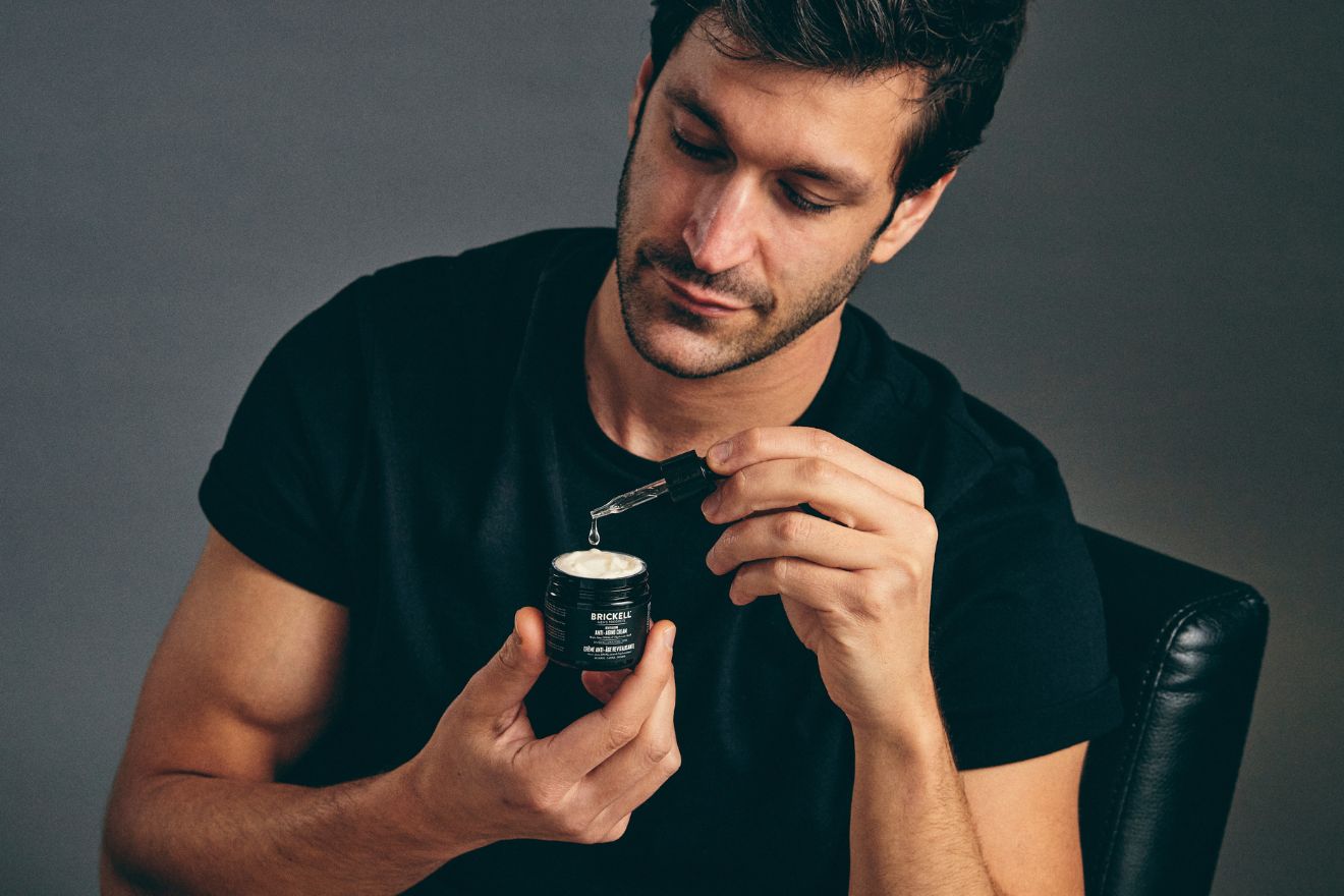 Man mixing booster with anti-aging cream