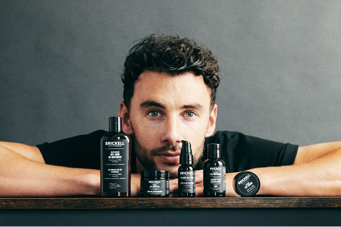 Man in front of skincare products