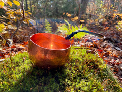 hand hammered copper mug with leather cord