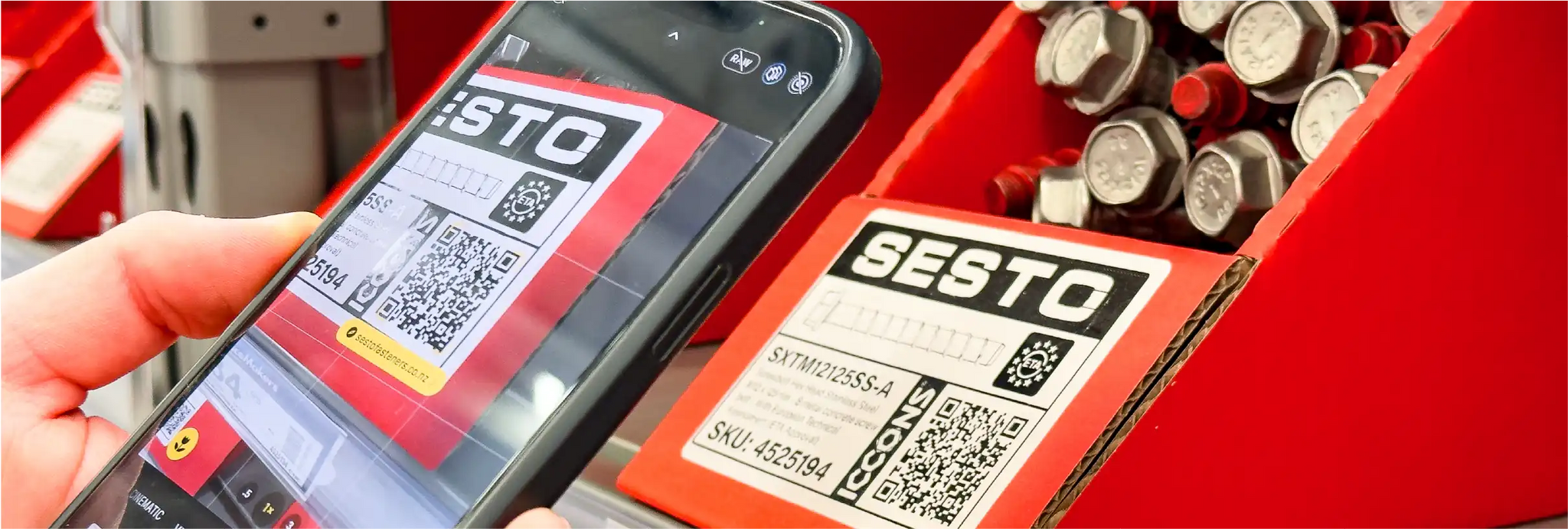 Phone scanning QR code on Sesto box.