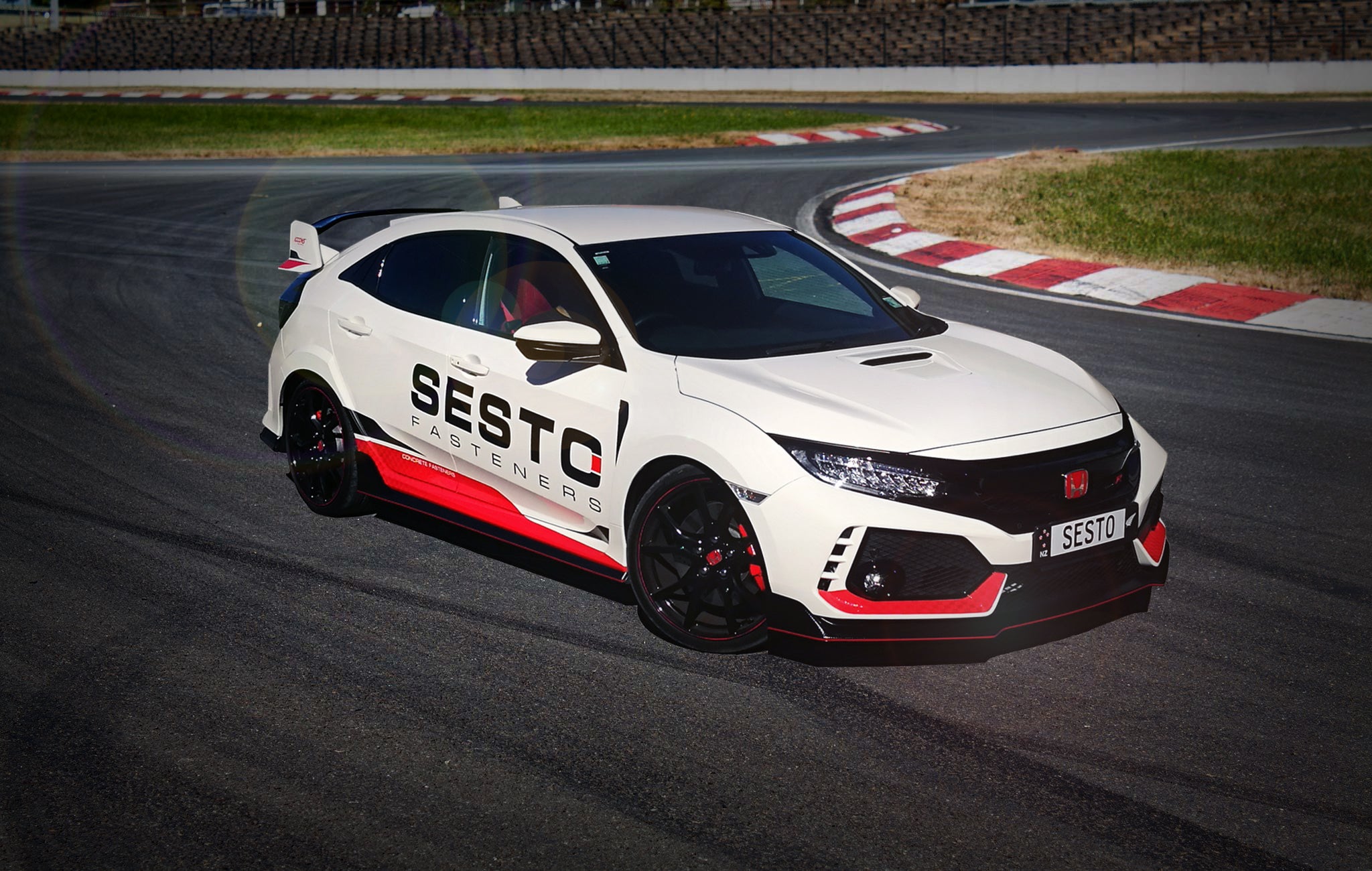 Honda Civic Type R with SESTO Fasteners decal graphics on the race track.