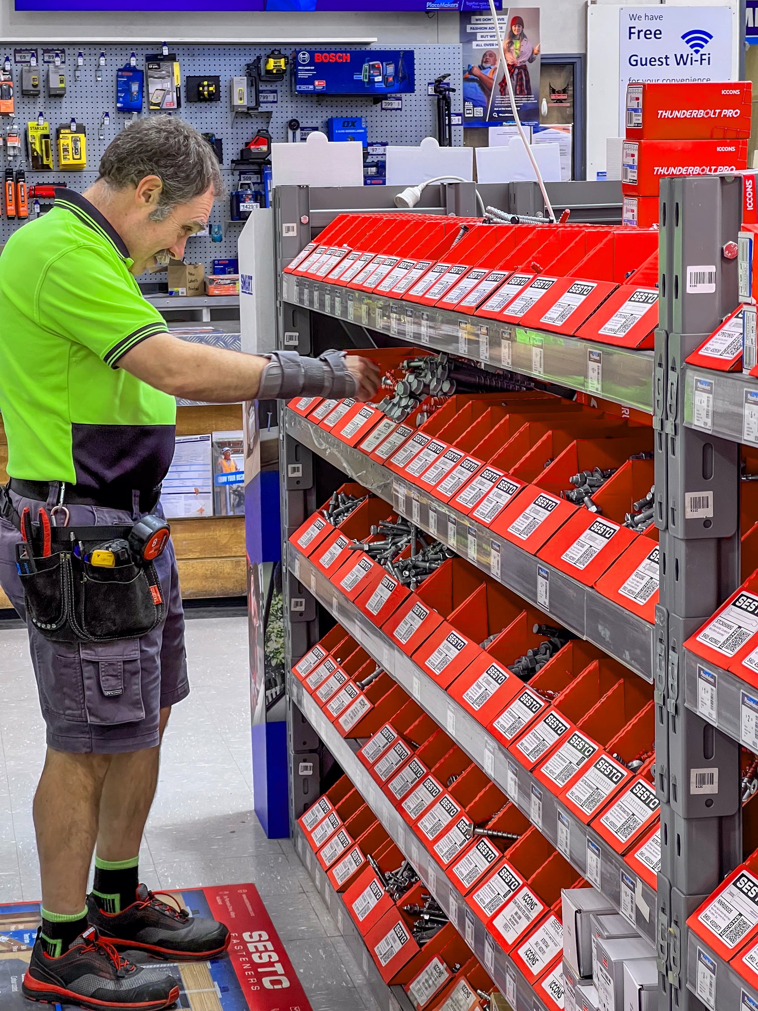 Customer tradesman searching through Sesto sales display racking.