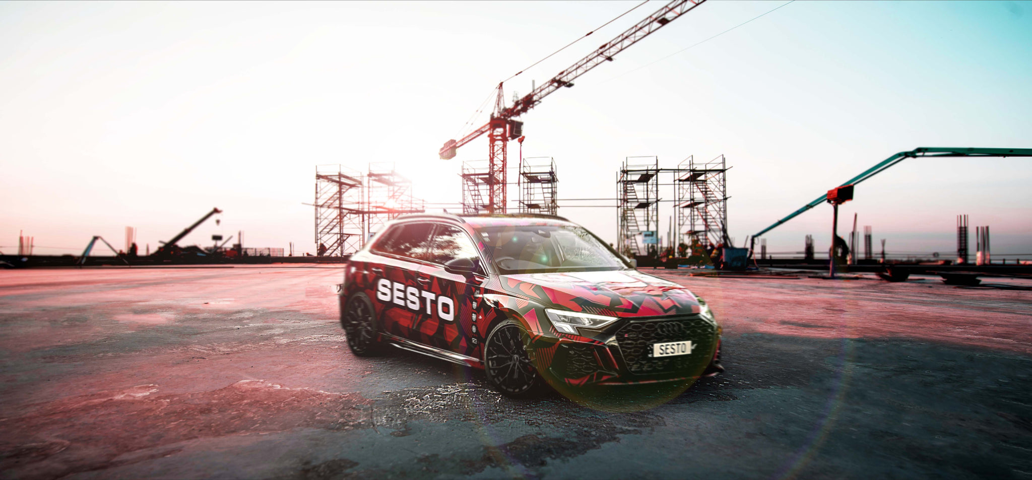 Audi RS3 with Sesto Fasteners wrap parked in a construction site.
