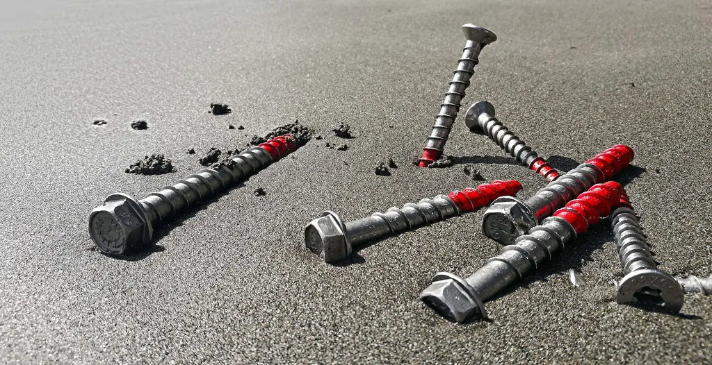Promo image showing ICCONS screwbolts arranged in sand on the beach.