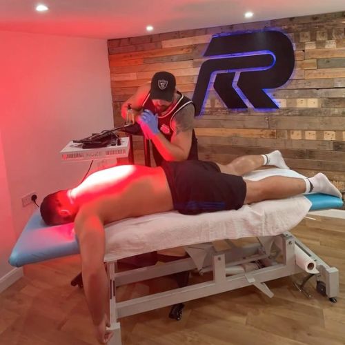 An image of a man getting redlight treatment on his back.