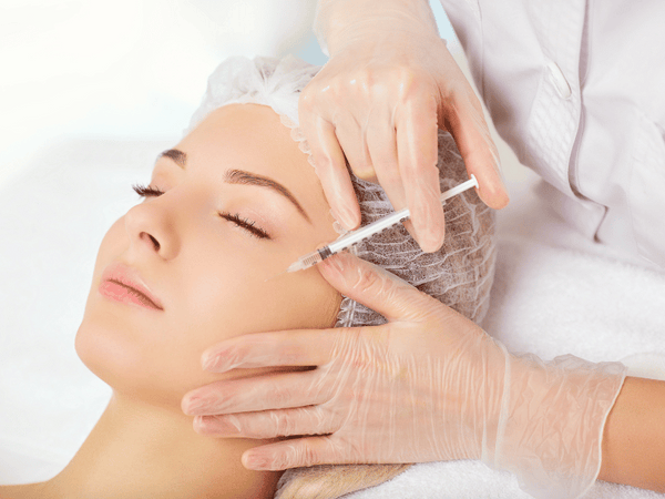 an image of a woman getting botox treatment on her face.