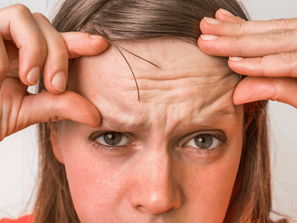 an image of a woman showing off her wrinkles.