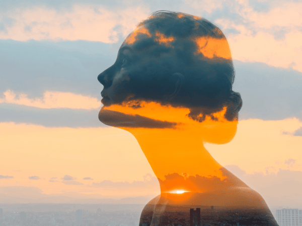 an image of a woman's silhouette along showing sunset