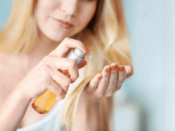 image of a woman taking care of her hair.