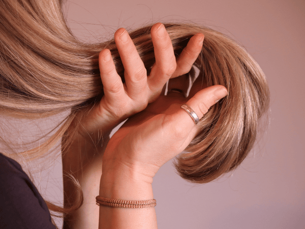 an image of a woman stroking her hair.