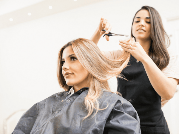 an image of a woman cutting her hair.