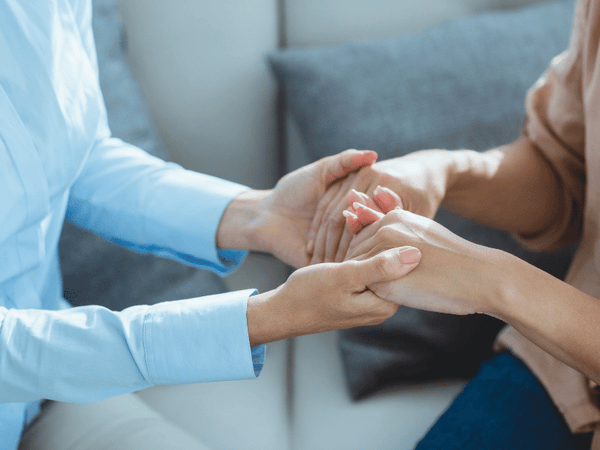 an image of 2 woman holding hands together.