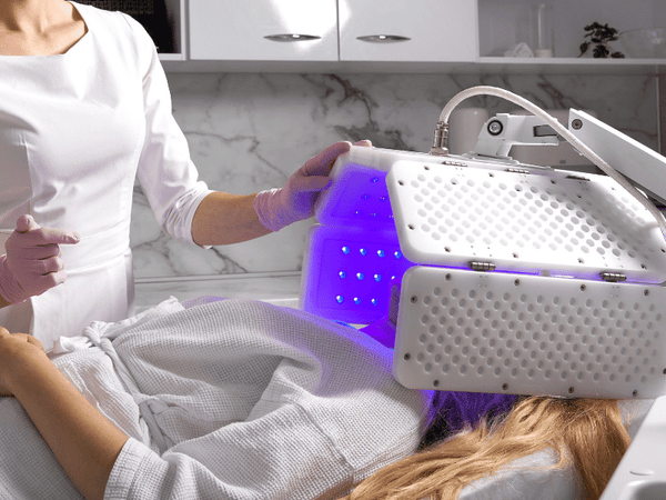 an image of a woman getting photodynamic treatment.