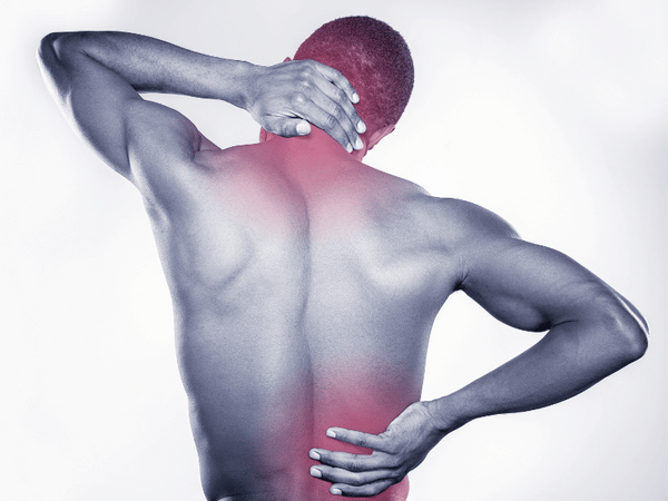 A man showing his back, who is holding his nape and lower back because of pain.