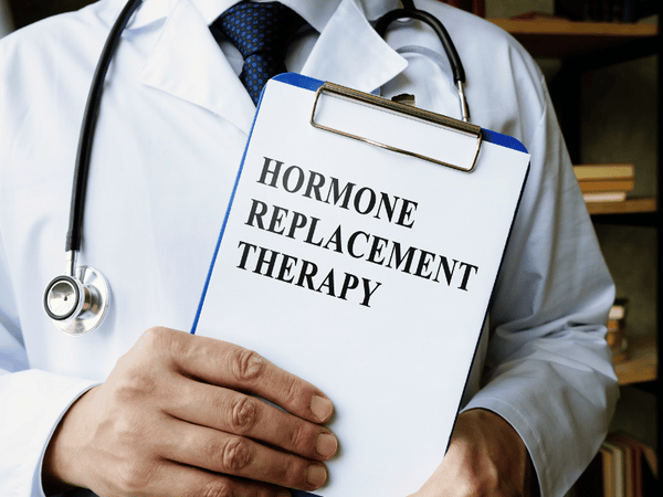 an image of a doctor holding a clipboard that says: Hormone replacement therapy