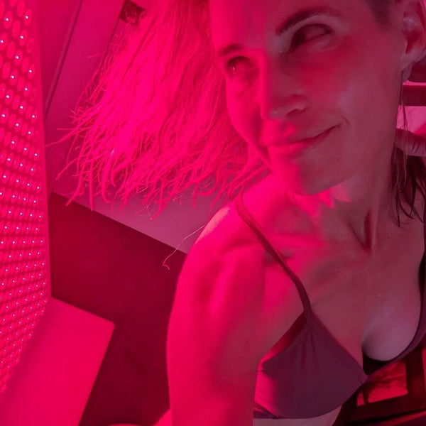 an image of a woman exposed to red light therapy.