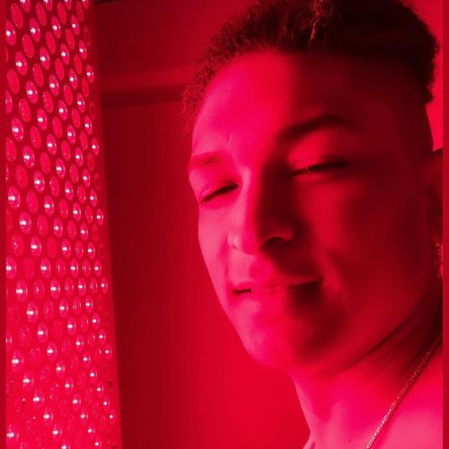 A man being treated to red light therapy.