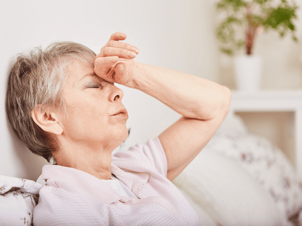 a middle-aged woman feeling dizzy.