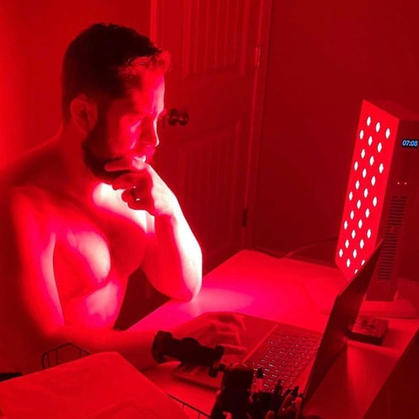 An image of a man getting red light therapy before going to bed.