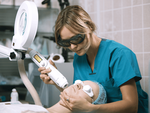 An image of a woman undergoing laser treatment.