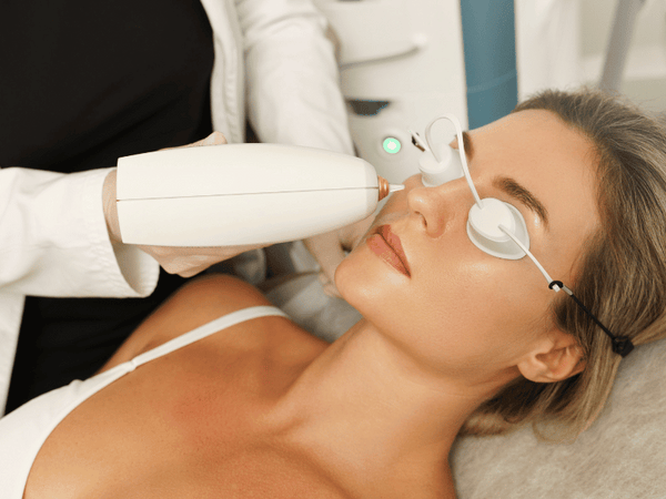 an image of a woman undergoing laser treatment on her face.