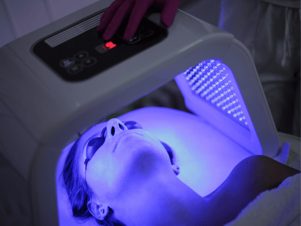 An image of a woman undergoing blue light treatment