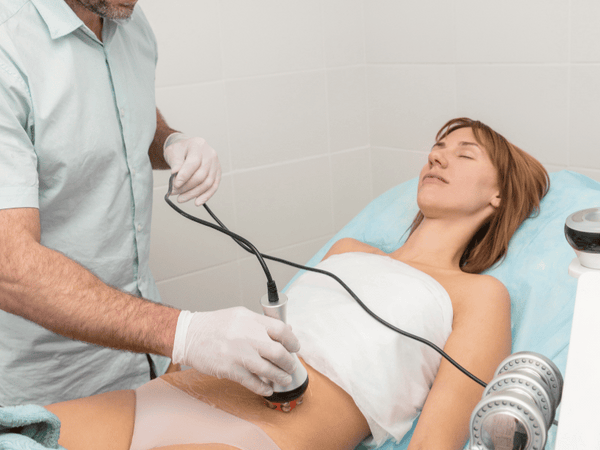 a lady getting radio frequency treatment skin tightening on her tummy.