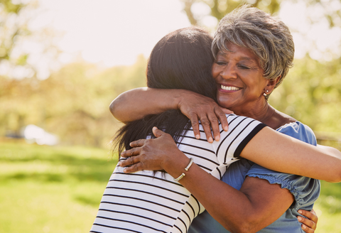 Two women hugging joyfully