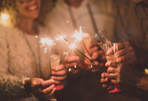 Group of happy people holding sparklers