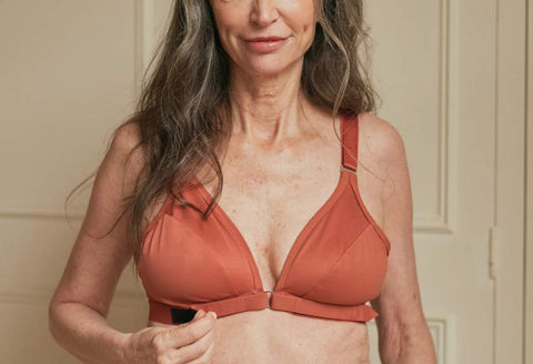 Close up of Springrose's adaptive bra on a model, who's showcasing the velcro front closure