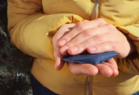 Gifts For Rheumatoid Arthritis: a close up of a woman's hands holding a hand warmer