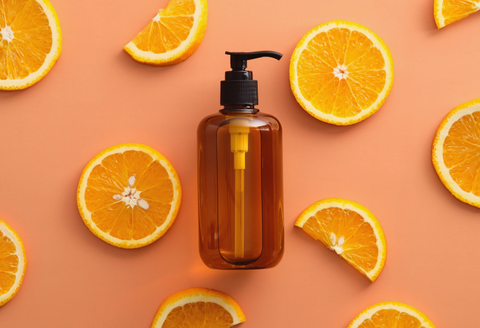 Broken hand tools: orange colored flatlay of a generic bottle with a pump dispenser, surrounded by slices of oranges