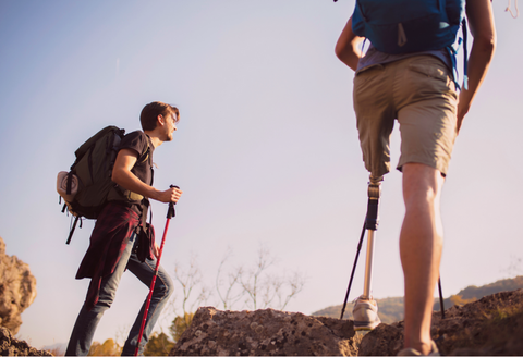 Why disability inclusion is important: image of two friends hiking, one has a prosthetic leg