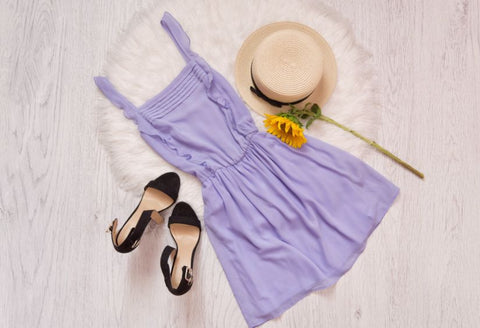 Best trigger finger clothing: a pretty flatlay of a lilac summer dress, a sun hat, and high heels