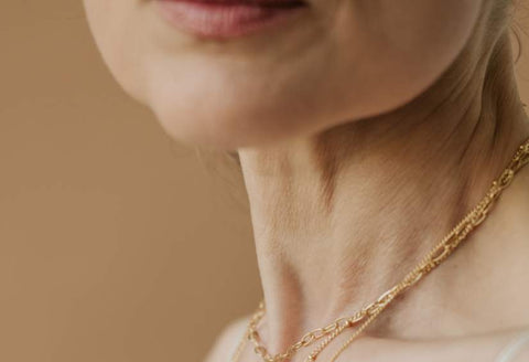 Gifts For Rheumatoid Arthritis: a close up of an older woman's neck and her gold necklace