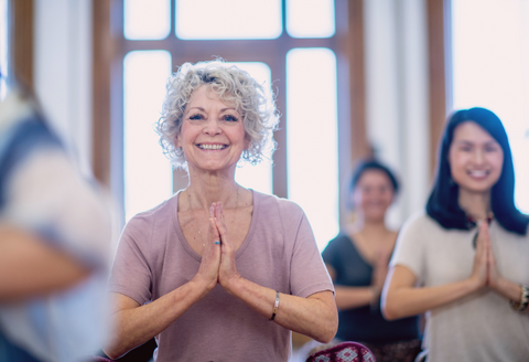 best gifts for someone with chronic pain: a woman doing yoga