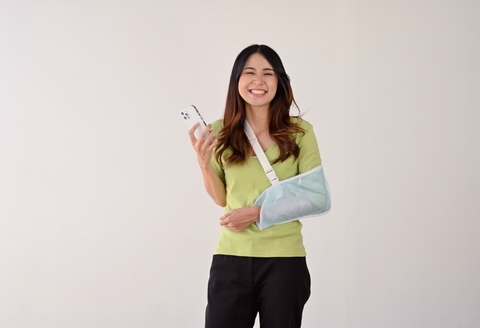 shoulder surgery bra: a woman wearing a sling and smiling