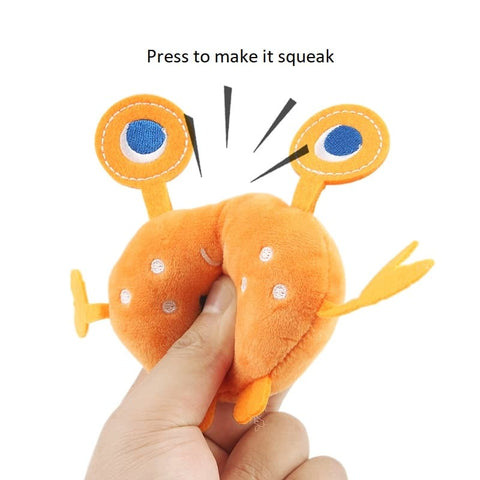 Human hand squeezing the Crab Squeaky Plush Toy