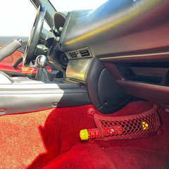 The compact Element fire extinguisher fits in the footwell storage of most cars