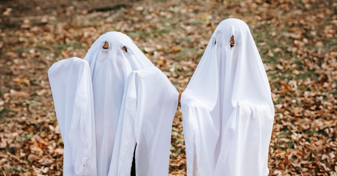 Two kids dressed as ghost using a potentially flammable bedsheet